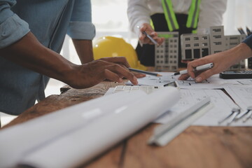 Construction and structure concept of Engineer or architect meeting for project working with partner and engineering tools on model building and blueprint in working site, contract for both companies.