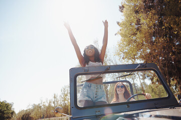 Happy women, excited and travel on road trip in nature and bonding together for adventure on...