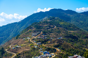 Fototapeta na wymiar Village Amidst Terraced Slopes on the Kutumsang-Chisopani Trek Route, Nepal