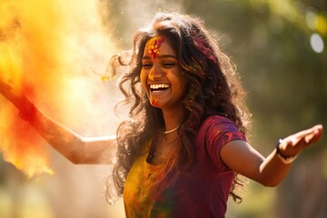 Naklejka premium Exuberant woman at Holi festival with colorful powder cloud