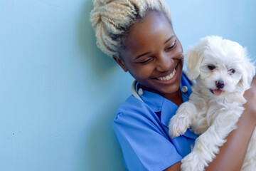 Portrait of a smiling black female veterinarian holding a puppy
