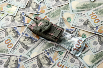 Tank on crumpled hundred dollar bills banknotes. Background of war funding and military support price for United States of America