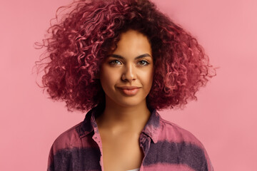 girl model. afro girl with lush bright pink curly hair and in a striped bright sweater, fashion concept