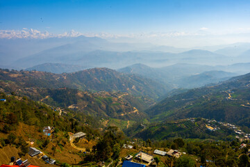 Fototapeta na wymiar Hazy Morning Over Layered Mountain Ridges and Villages in Dhulikhel, Nepal