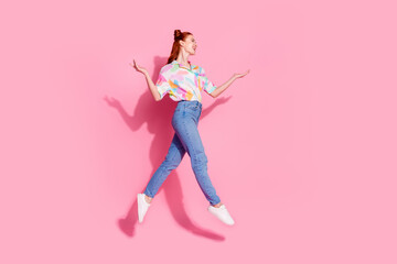 Fototapeta na wymiar Full body size photo of red hair curly hair hipster lady jump trampoline raised arms up look novelty isolated on pink color background