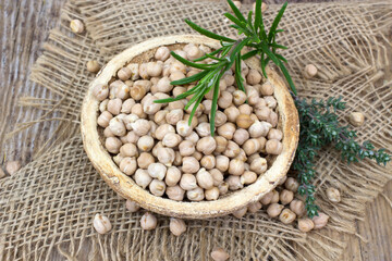 chickpeas in a basket and fresh herbs - 757300251