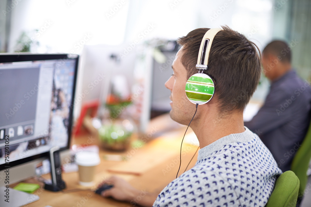 Poster business, designer and man with headphones at computer screen in office for creative internship and 