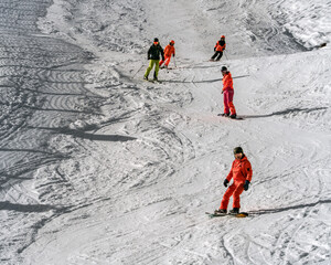 Vibrant skiers and snowboarders descend a snowy mountain, capturing the essence of winter sports...
