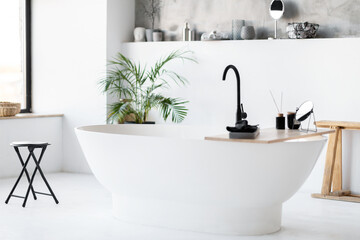 Chic, minimalist bathroom with modern striking freestanding tub, interior shot