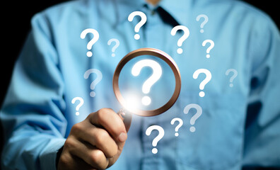 The concept of finding an answer to complex questions in business. Hand holding a magnifying glass...
