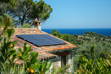 Solar photovoltaic panels on the tiled roof of house against the backdrop of Mediterranean landscape. Alternative environmentally friendly energy generation. Eco solar panels, modern technologies