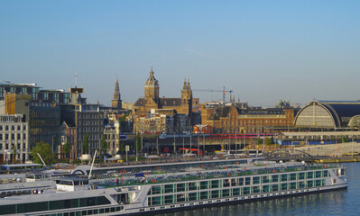 Amsterdam in Holland, famous river cruise ship cruiseship travel destination with docking downtown...
