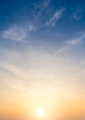 Sunset sky clouds vertical in the evening summer with orange, yellow sunlight in golden hour or...