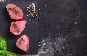 fresh raw tuna fillets on black background