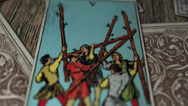 Las Vegas, USA - January 31, 2021: Tarot Cards. Close Up. Five Of Wands Image. Men In Different Outfits Fighting. Meaning Is Conflict, Tension And Competition With Others. Future And Fortune Reading.