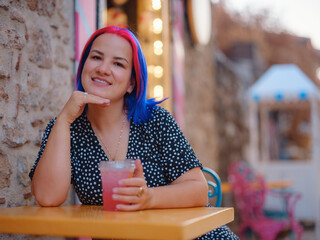 female summer old town walk in Antalya Turkey. Woman with colorful hair and dress strolls through...