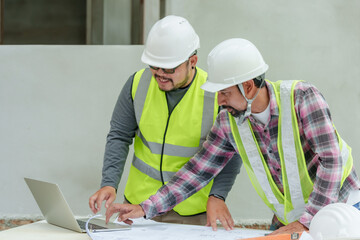 Asian male architect with construction supervisor worker engineer employee Wear white safety...
