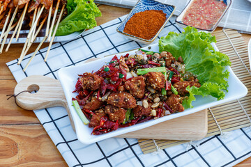 Crispy crunchy Spicy Chili Chicken cooked with bits of meat, chilies, peppercorns, peanuts, and...