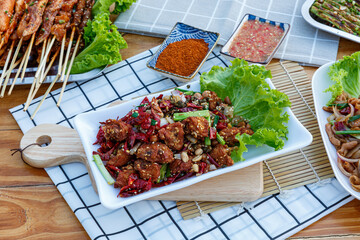 Crispy crunchy Spicy Chili Chicken cooked with bits of meat, chilies, peppercorns, peanuts, and cilantro.