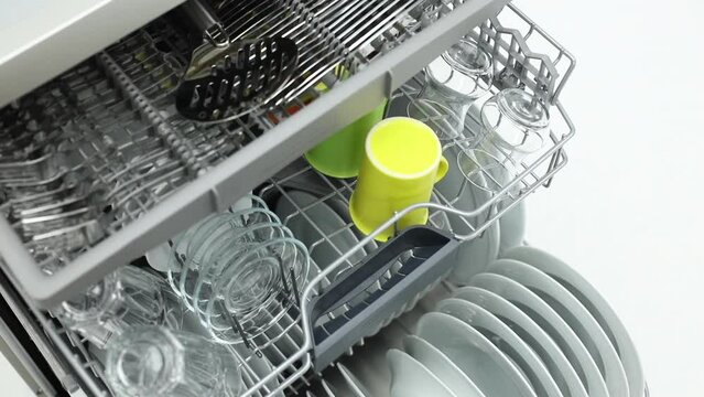 Putting cutlery in dish washer