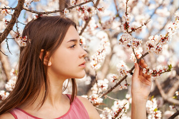 Young beautiful woman in a blooming garden