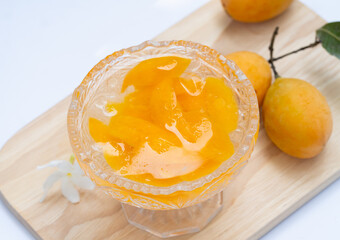 Marian Plum in Syrup Processing fruit by soaking it in syrup and refrigerating it. Sliced ​​mangosteen in syrup mixed with ice in a clear glass cup. Thai dessert.