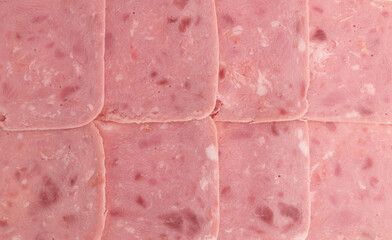 slices of pork ham sausage as background, close up, top view