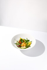 Vegetable salad bowl with avocado and cheese tempura balls on an isolated white background