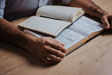 Man is ready to study the Bible and make notes in his notebook