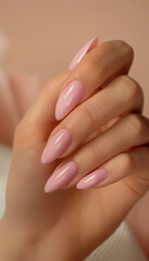 Fototapeta premium Closeup image of beautiful woman's hands with light pink manicure on the nails skin care for hands