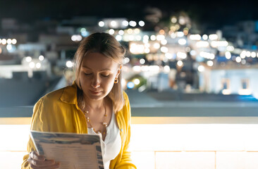 Woman is looking at menu at the rooftop restaurant.