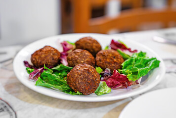 Greek meatballs with lettuce on a plate. - 757349488