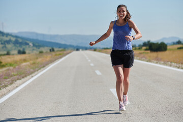 A determined woman athlete trains for success in the morning sun.