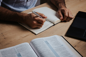 Man is ready to study the Bible and make notes in his notebook