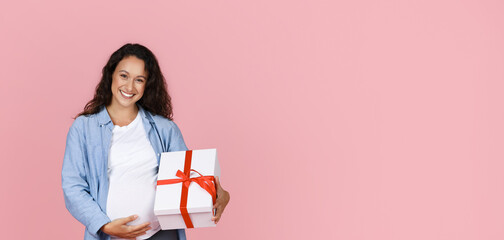 Positive young expecting lady holding gift box, web-banner