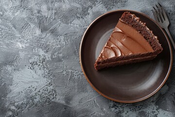 Plate with slice of tasty homemade chocolate cake on grey table. Space for text