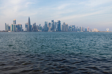 Obraz premium Doha Towers in the morning with the blue sky reflected in the sea, this photo was taken from the Doha corniche