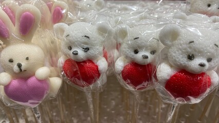 lollipop on a stick. lollipop in the shape of a polar bear with a red heart. candy in transparent...