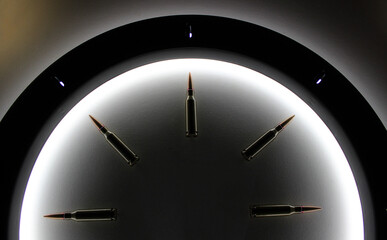 Top part of classic clock dial made of bullets inside a circle of light concept for military watch...