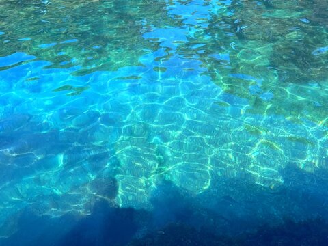 Blue turquoise sea water with pebbles