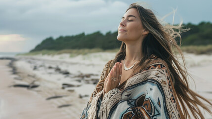 Young woman wearing colorful poncho relaxing in beautiful nature. Spirituality, harmony and connection with nature concept. - obrazy, fototapety, plakaty