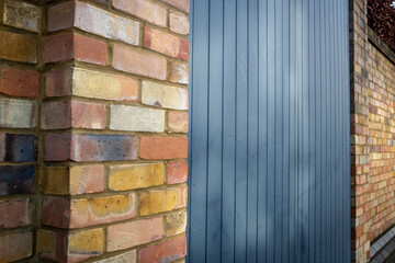 UK- Modern secure garden door and clay brick wall