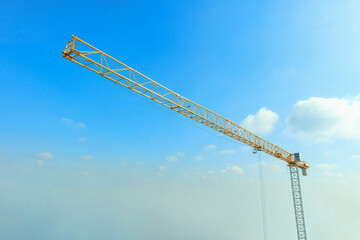 Industrial construction crane with blue sky background at building site
