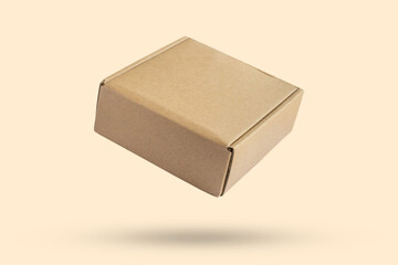 Mockup brown cardboard box isolated on brown background