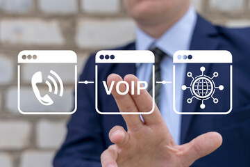 VOIP telecommunication concept. Business man using virtual touch screen presses abbreviation: VOIP....