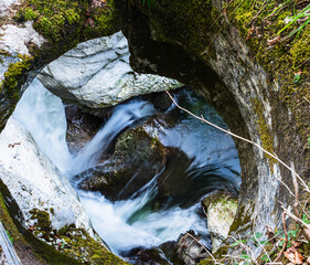 Hole in rocks showing stream strength in Gorges du Fier - obrazy, fototapety, plakaty