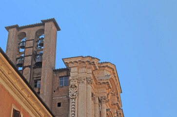 Roman campanile at the baroque Santa Maria in Campitelli church, also called Santa Maria in Portico, in Rome, with blue sky - obrazy, fototapety, plakaty