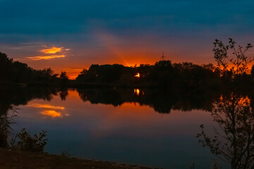 Summer sunset with reflections near Plattling, Isar, Bavaria, Germany