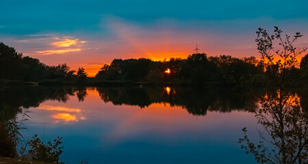 Summer sunset with reflections near Plattling, Isar, Bavaria, Germany