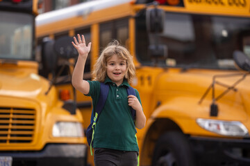 Child go to school. Schoolboy getting on school bus. American School. Happy children ready to...